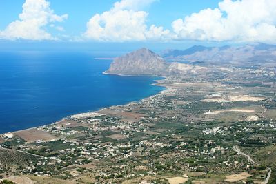 Aerial view of sea and mountains against sky