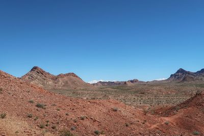 Scenic view of mountains against clear blue sky