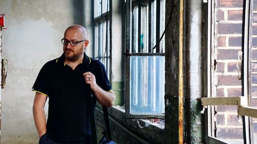 Man standing by window in room