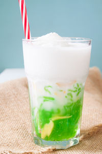 Close-up of ice cream and drink in glass on table