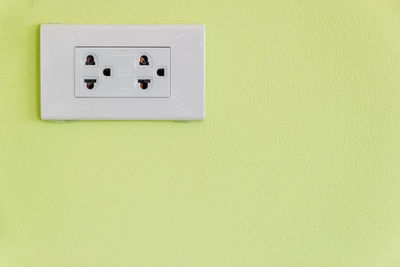 Close-up of electric outlet on wall