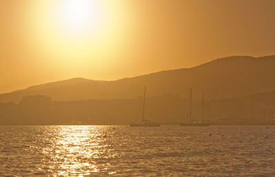 Scenic view of sea against orange sky