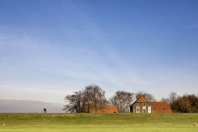 House on field against sky