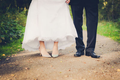 Low section of woman standing on ground