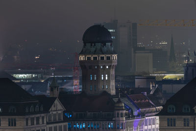 Buildings in city at night
