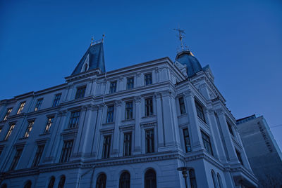 Low angle view of building against blue sky