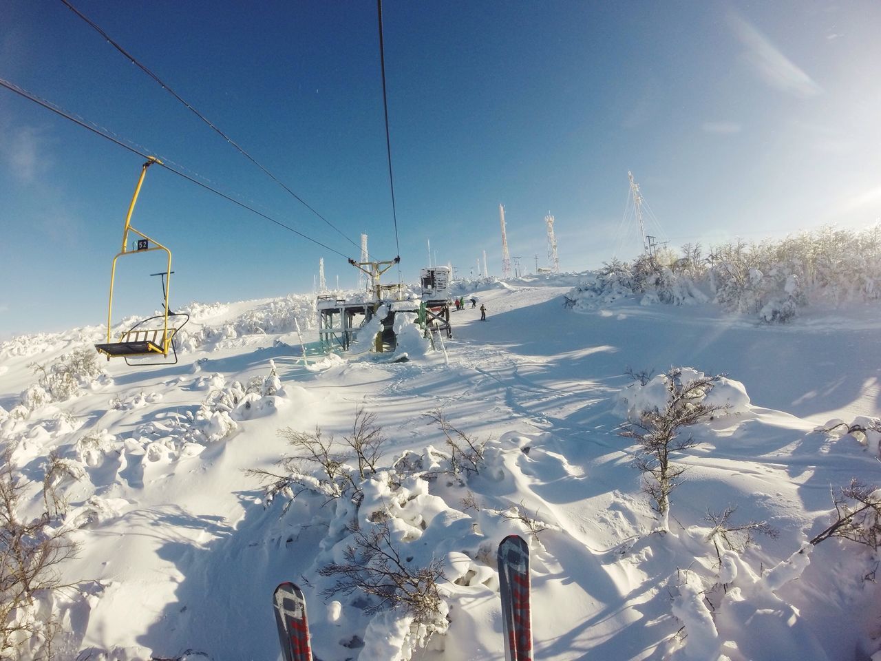 snow, winter, cold temperature, transportation, mode of transport, season, landscape, sky, weather, mountain, nature, sunlight, ski lift, field, covering, overhead cable car, day, white color, beauty in nature, non-urban scene