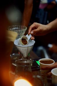 Cropped hand pouring coffee in cup