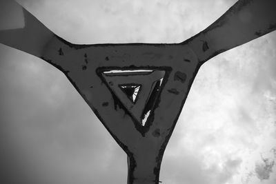 Low angle view of old machinery against sky