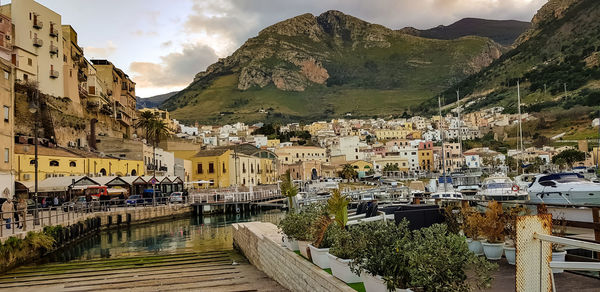 Panoramic shot of townscape and mountains against sky