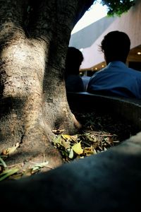 Man sitting by tree