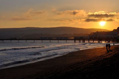 Scenic view of beach against sky during sunset