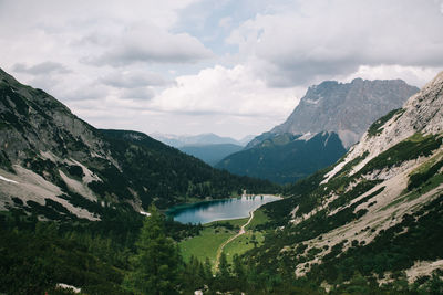 Scenic view of lake and mountains against sky