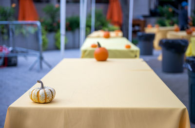 Tables on a street market decorated with fresh pumpkins on halloween event at union square, nyc