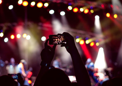 People photographing at music concert