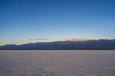 Scenic view of mountains against clear blue sky