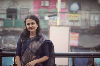 Portrait of smiling young woman standing outdoors