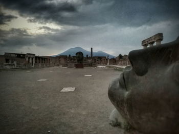 Houses against cloudy sky