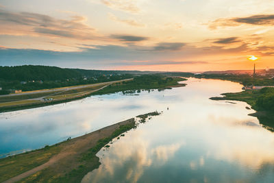 Scenic view of river against sky during sunset