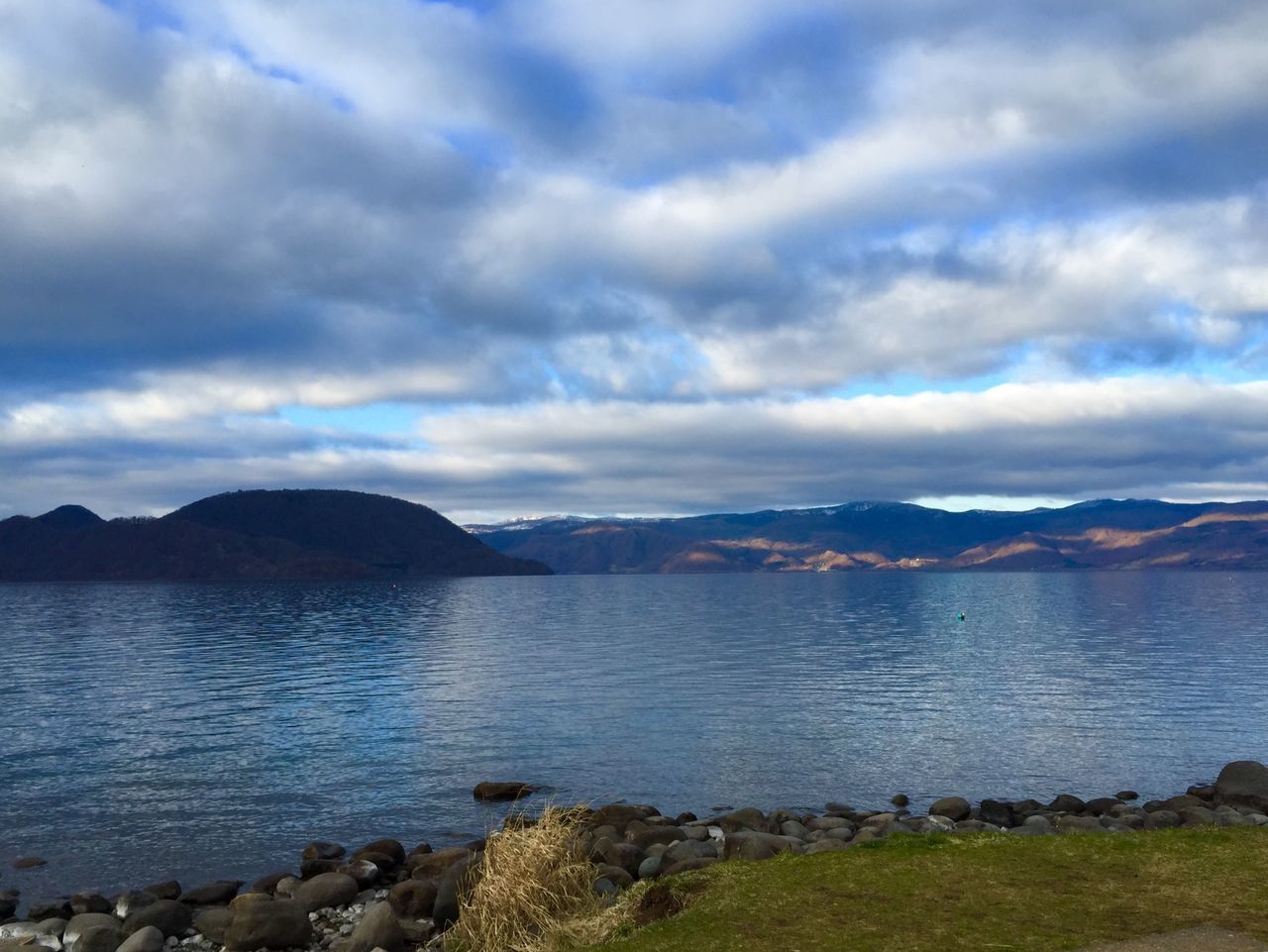 sky, cloud - sky, mountain, water, tranquil scene, scenics, tranquility, cloudy, beauty in nature, mountain range, nature, cloud, lake, weather, overcast, landscape, idyllic, sea, non-urban scene, river