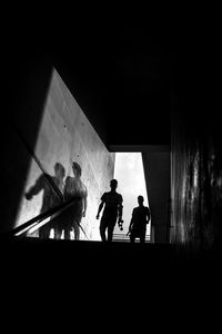 Silhouette people standing on staircase