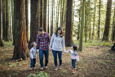 Attentive mother and father enjoying time with their kids outdoors.