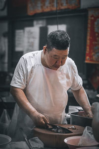 Midsection of man working at restaurant