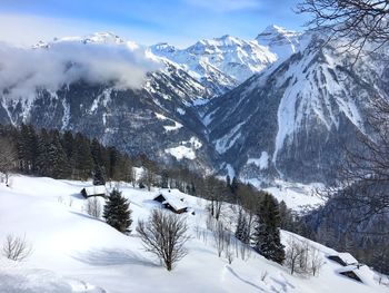 Scenic view of snow covered mountains against sky