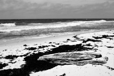 Scenic view of sea against cloudy sky