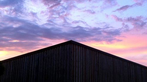 Low angle view of building against cloudy sky