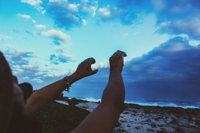 Cropped image of person looking at sea