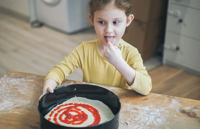 Portrait of smiling woman with chocolate at home