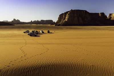 High angle view of off-road vehicles on sand at desert