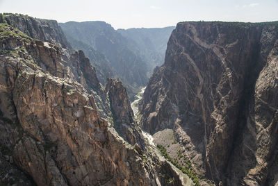 Aerial view of river flowing river amidst rock mountain