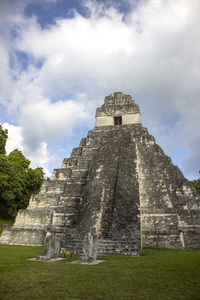 Low angle view of temple against cloudy sky