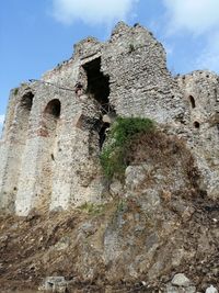 Low angle view of old ruin building against sky