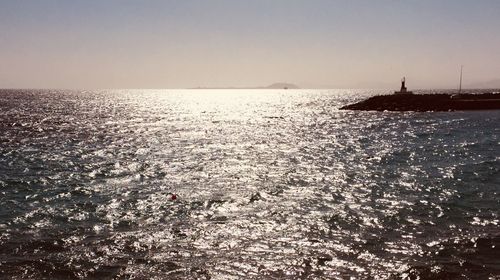 Scenic view of sea against clear sky during sunset