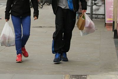 Low section of couple walking outdoors