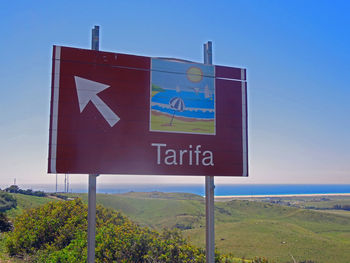 Road sign against sky