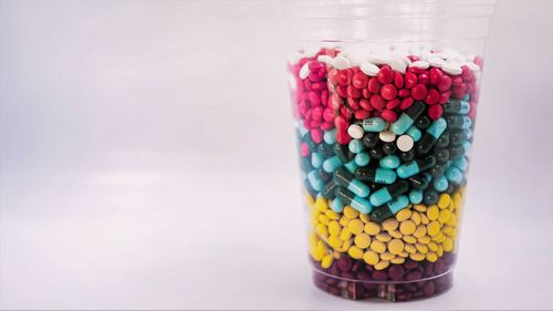 Close-up of multi colored candies in glass on table