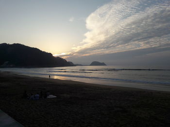 Scenic view of beach against sky during sunset