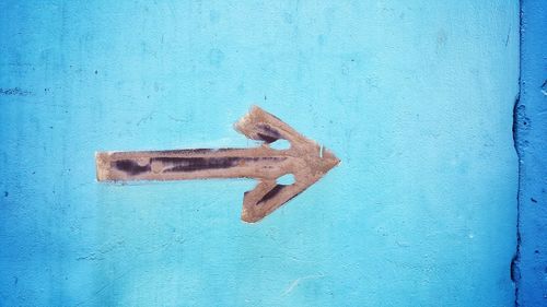 Close-up of rusty sign on wood