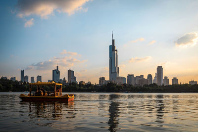 Boats in river with buildings in background