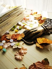 Portrait of a messy table filled with tiny flowers and leafs for scrapbook material