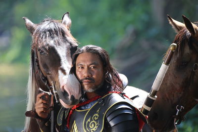 Man in warrior costume with horse