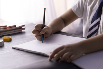 Close-up of hand holding book