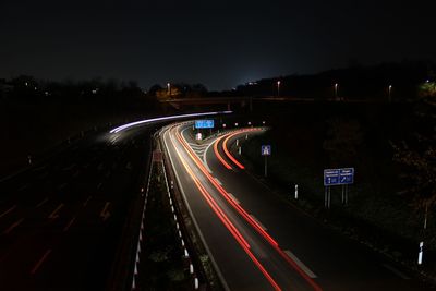 High angle view of light trails on highway at night