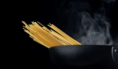 Close-up of colored pencils against black background