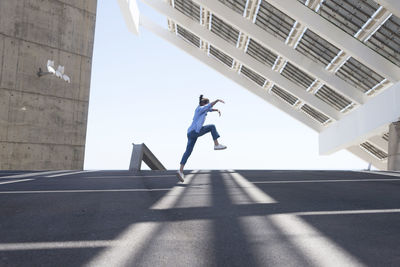 Low angle view of man jumping in office building