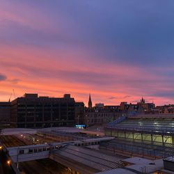 Buildings in city at sunset